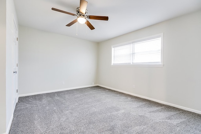 empty room featuring carpet floors and ceiling fan