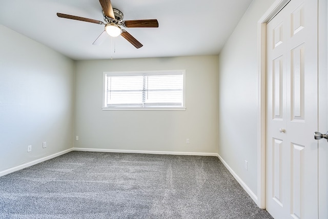 carpeted empty room featuring ceiling fan