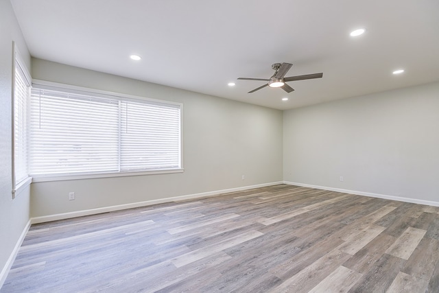 spare room with light hardwood / wood-style floors and ceiling fan