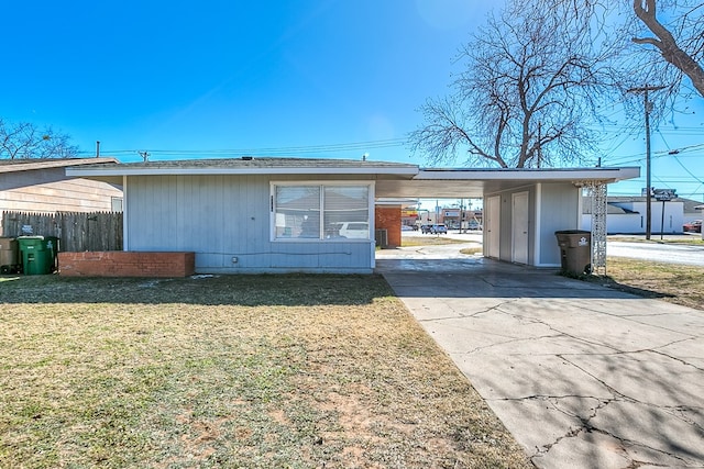 exterior space with a carport and a front lawn