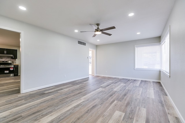 empty room featuring ceiling fan and light wood-type flooring