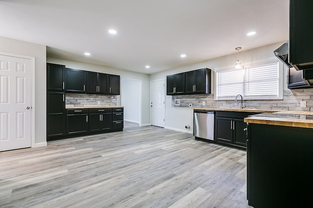 kitchen featuring sink, wooden counters, hanging light fixtures, light hardwood / wood-style floors, and stainless steel dishwasher