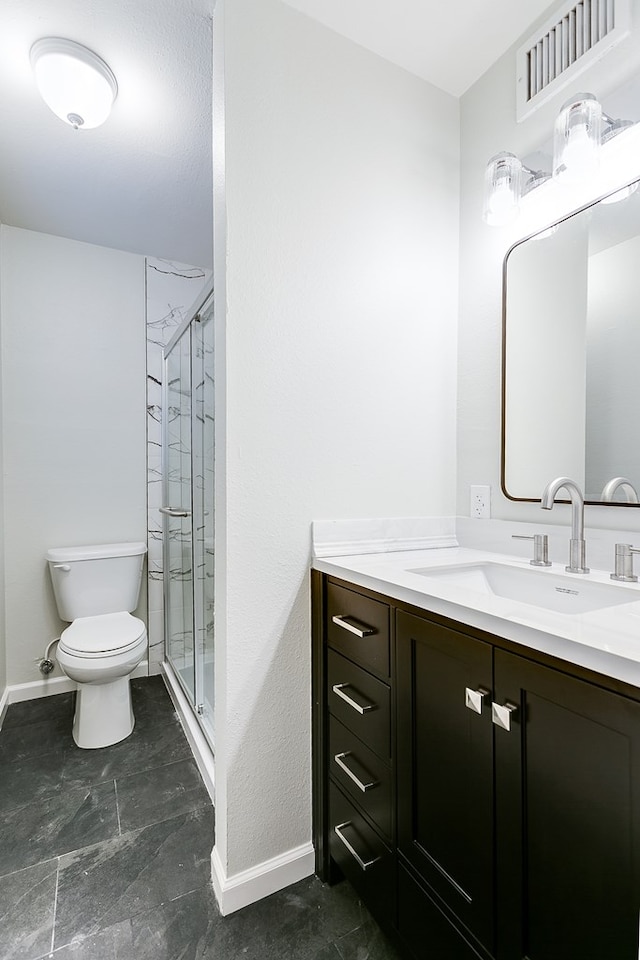 bathroom with vanity, a shower with shower door, and toilet