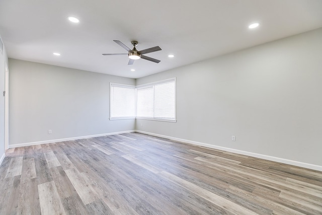 spare room with ceiling fan and light hardwood / wood-style flooring