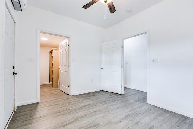 unfurnished bedroom with ceiling fan and light wood-type flooring