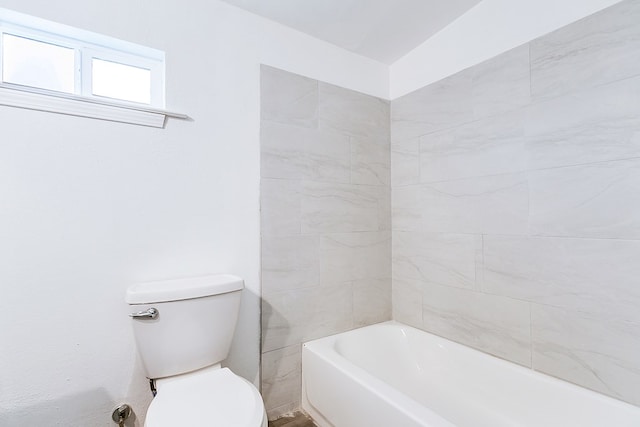 bathroom with toilet and a washtub