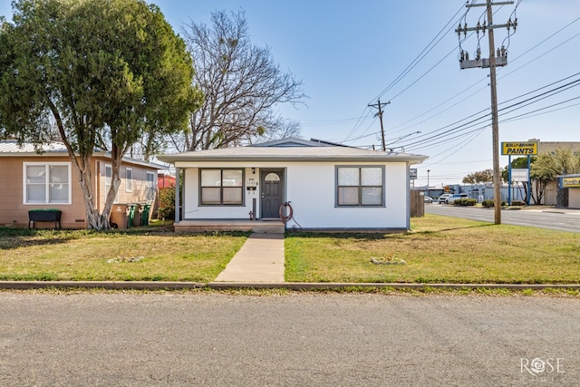 bungalow-style house featuring covered porch and a front lawn