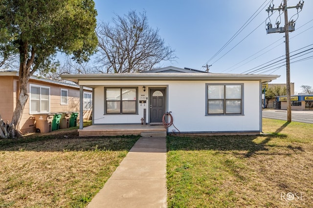 bungalow-style house with covered porch and a front lawn