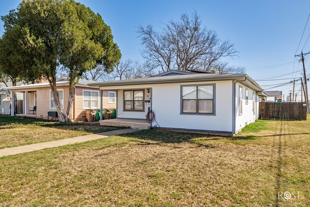 ranch-style home featuring a front yard and fence