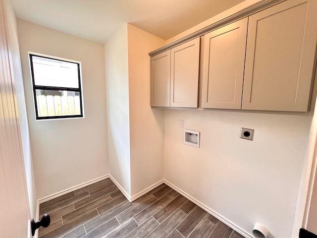317 E 25th St, San Angelo, TX 76903 - washroom with electric dryer hookup, hookup for a washing machine, dark wood-style floors, and cabinet space