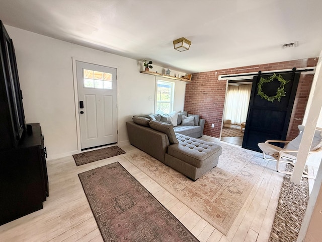 1702 Ellis St, San Angelo, TX 76905 - living room with light wood-style flooring and a barn door