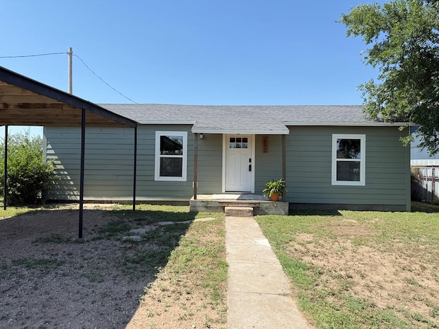 1702 Ellis St, San Angelo, TX 76905 - view of front of home with a front lawn and a shingled roof