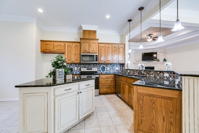 kitchen with sink, crown molding, appliances with stainless steel finishes, dark stone counters, and decorative backsplash