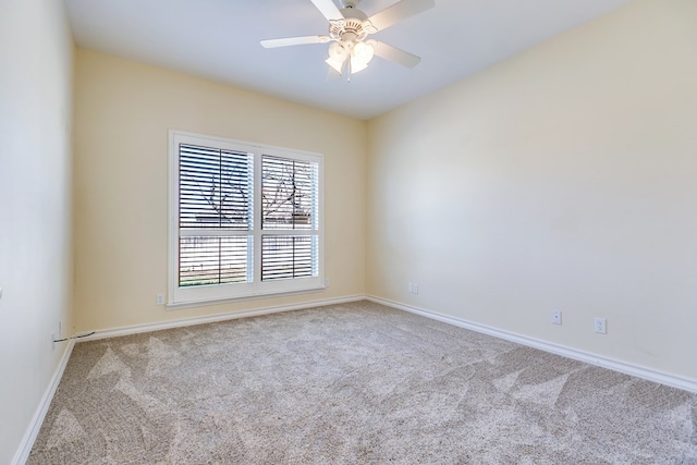 carpeted spare room with ceiling fan