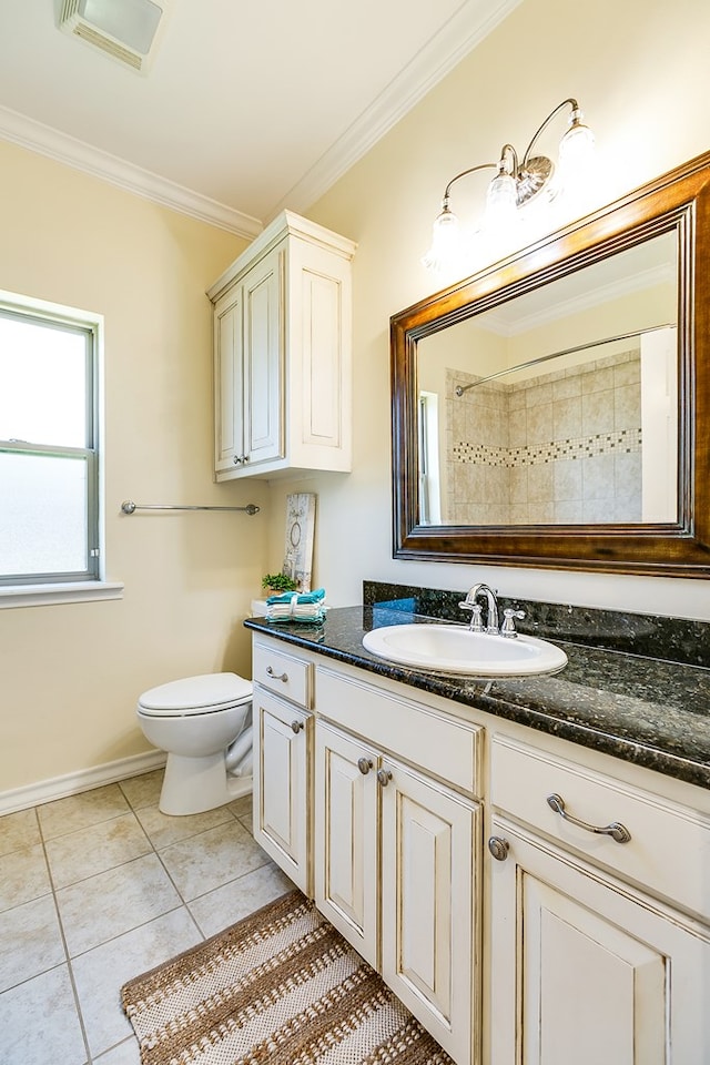 bathroom with tile patterned flooring, crown molding, vanity, and toilet