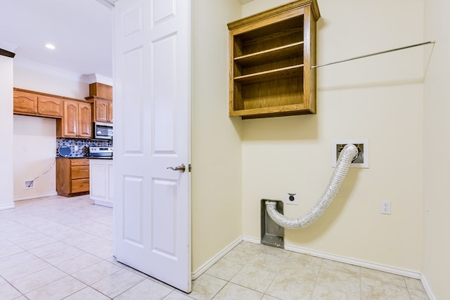 laundry area with crown molding, hookup for an electric dryer, and light tile patterned floors