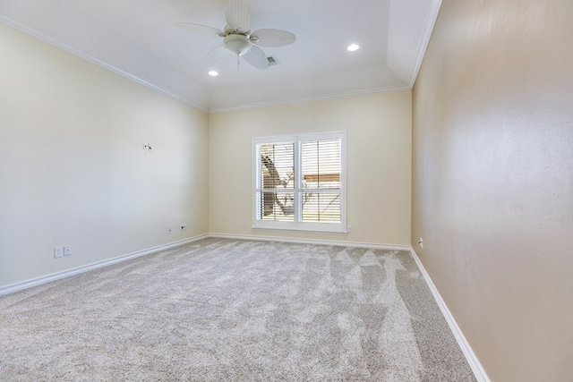 carpeted spare room with ceiling fan and ornamental molding