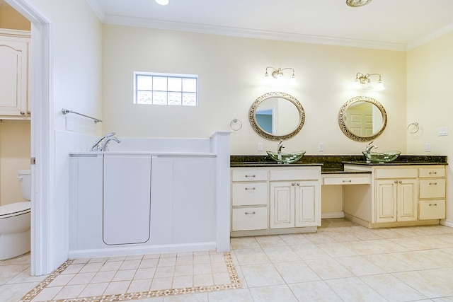 bathroom featuring a bathing tub, tile patterned flooring, vanity, toilet, and crown molding