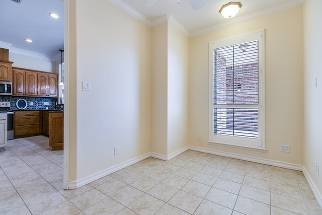 tiled spare room with crown molding and ceiling fan