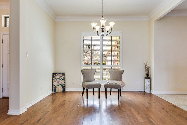 sitting room featuring a notable chandelier, crown molding, and plenty of natural light