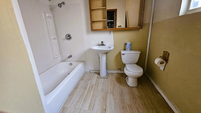 bathroom with sink, hardwood / wood-style flooring, and toilet