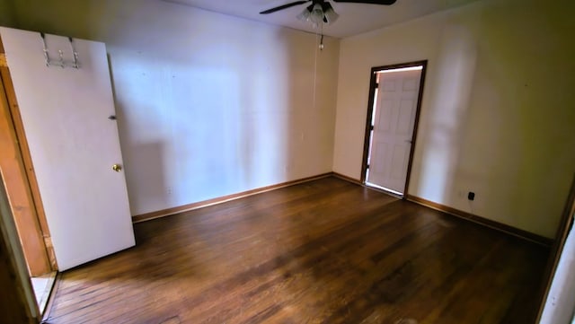 empty room with dark wood-type flooring and ceiling fan