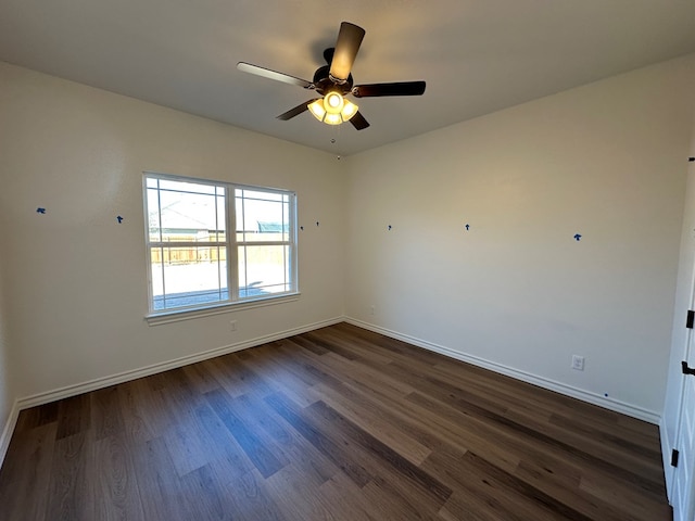 spare room with ceiling fan and dark hardwood / wood-style floors