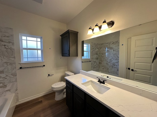 full bathroom with vanity, hardwood / wood-style floors, tiled shower / bath combo, and toilet