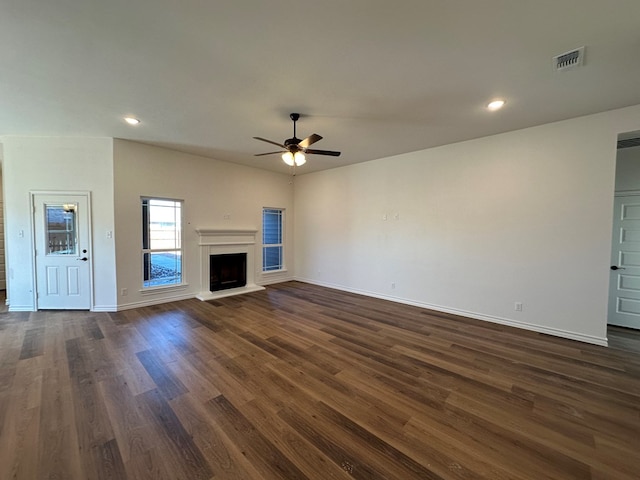 unfurnished living room featuring ceiling fan and dark hardwood / wood-style flooring