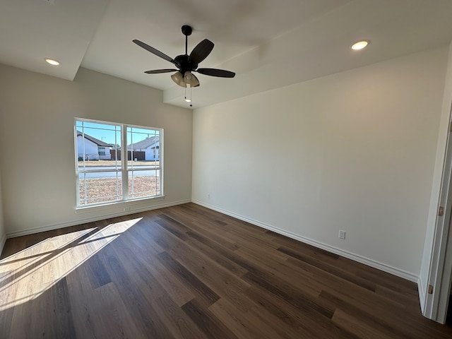 empty room with dark hardwood / wood-style floors and ceiling fan