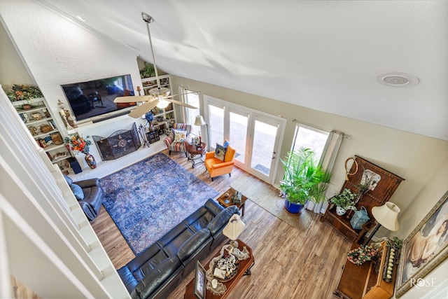 living room with vaulted ceiling and wood finished floors