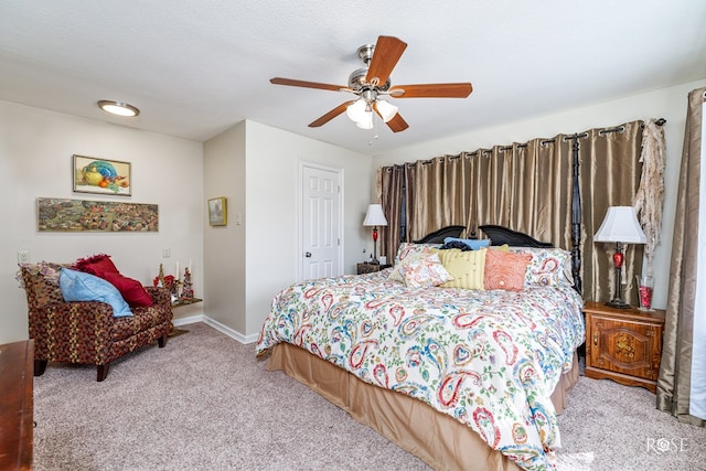 carpeted bedroom featuring a ceiling fan and baseboards