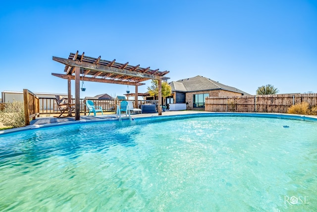 view of pool with a fenced in pool, fence, and a pergola