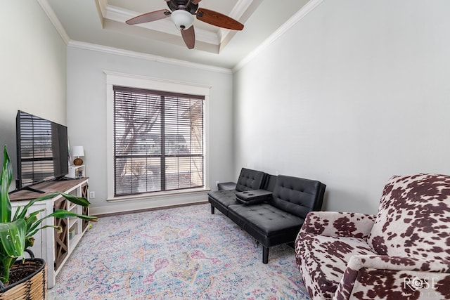 sitting room with baseboards, a raised ceiling, ceiling fan, and ornamental molding