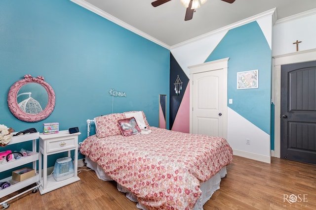 bedroom featuring ceiling fan, wood finished floors, baseboards, and ornamental molding