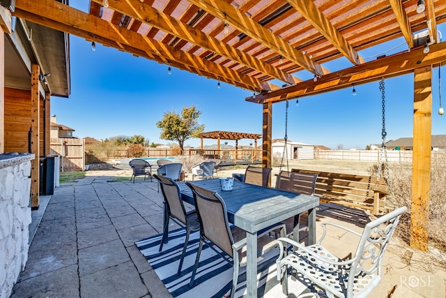 view of patio featuring a pergola, outdoor dining area, and a fenced backyard