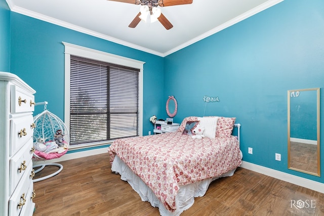 bedroom featuring crown molding, wood finished floors, baseboards, and ceiling fan