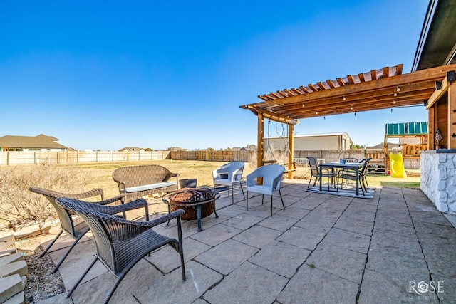 view of patio featuring outdoor dining area, a fire pit, a fenced backyard, and a pergola