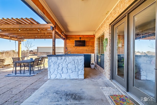 view of patio / terrace with outdoor dining area and outdoor dry bar