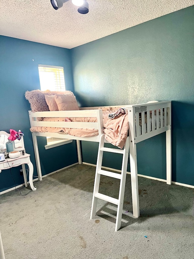 unfurnished bedroom featuring a textured ceiling and carpet flooring