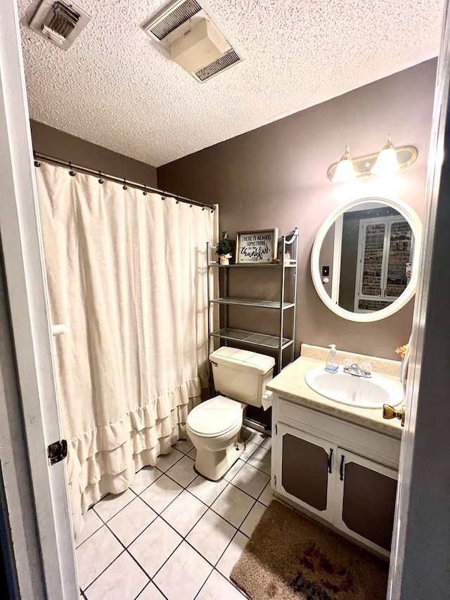 full bath with visible vents, toilet, vanity, a textured ceiling, and tile patterned floors