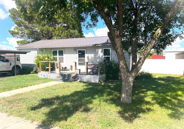single story home with a wooden deck and a front lawn