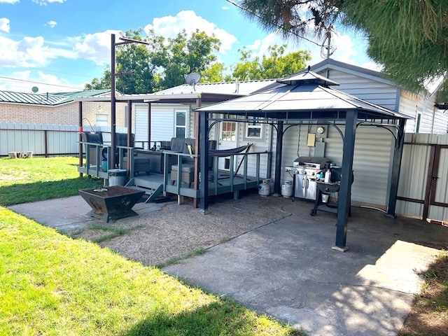 back of house featuring a gazebo and a lawn