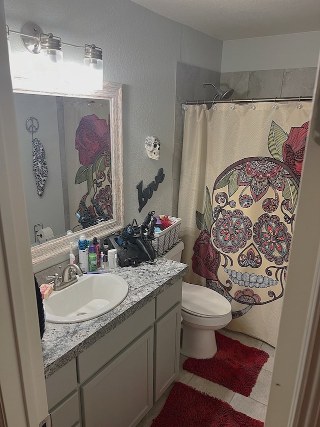 bathroom featuring tile patterned flooring, vanity, a shower with curtain, and toilet