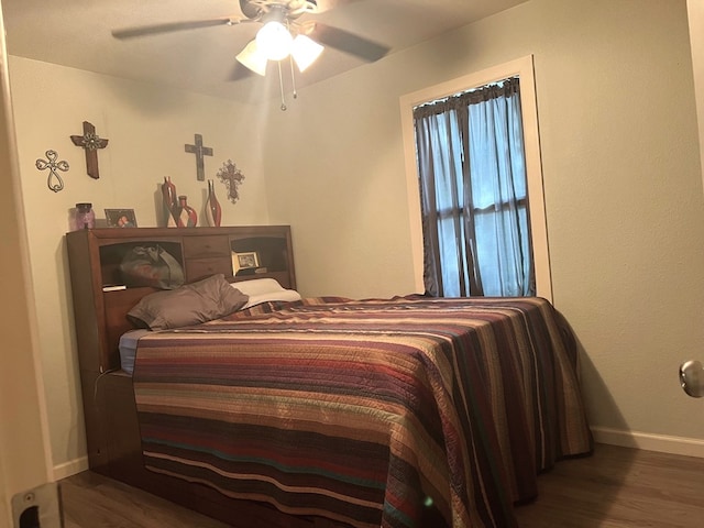 bedroom featuring dark hardwood / wood-style flooring and ceiling fan