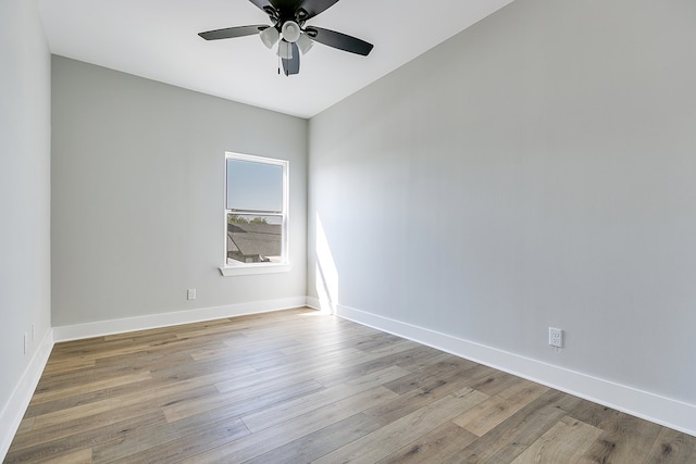 empty room with ceiling fan and light hardwood / wood-style floors