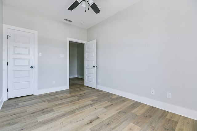 unfurnished bedroom with ceiling fan and light wood-type flooring