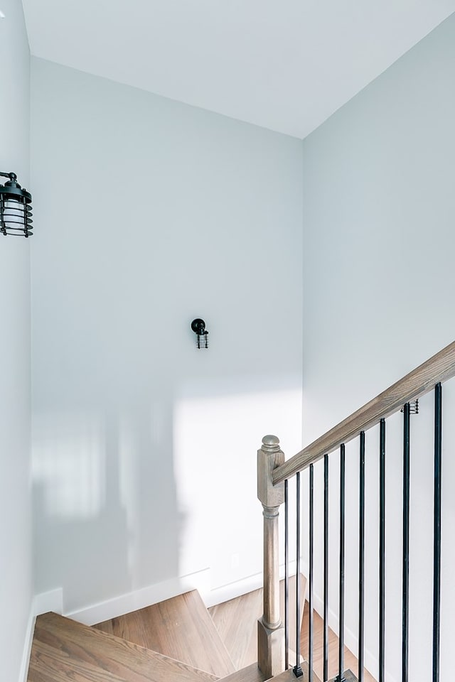 stairs featuring hardwood / wood-style floors