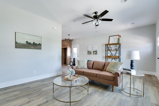 living room featuring ceiling fan and light hardwood / wood-style floors