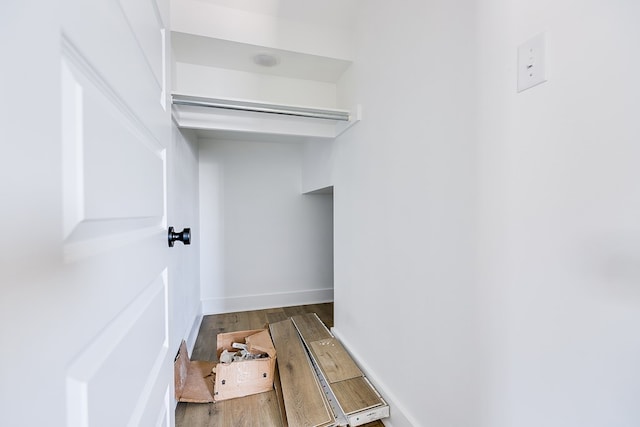 walk in closet with wood-type flooring